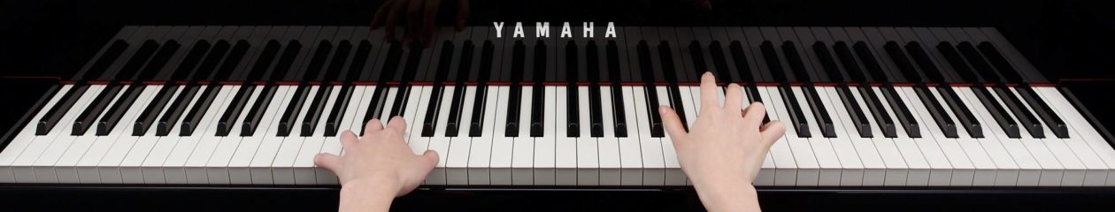 Child playing piano during a beginner piano lesson in Derby